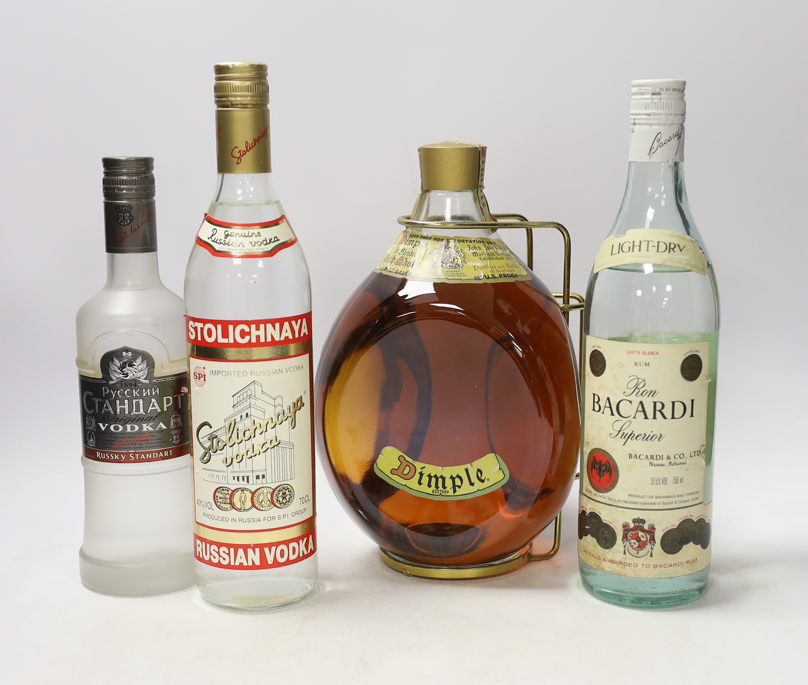 Four bottles of spirits including a half US gallon of Dimple, Bacardi Superior, Russian standard and Stolichnaya